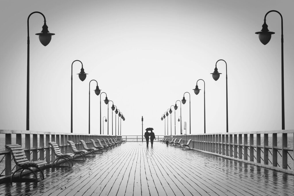 A Couple walking in the rain using an umbrella